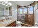 Bathroom features a tiled glass shower, granite vanity, and decorative mirror, showcasing style at 12820 Butler Bay Ct, Windermere, FL 34786