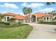 Charming front exterior with a circular driveway, lush landscaping, and a two-car garage at 12820 Butler Bay Ct, Windermere, FL 34786