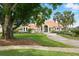 Beautiful home with a well-manicured lawn, mature trees, and a welcoming driveway at 12820 Butler Bay Ct, Windermere, FL 34786