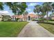 Inviting front exterior of home with a well-kept lawn, palm trees, and ample parking at 12820 Butler Bay Ct, Windermere, FL 34786