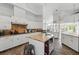 Bright kitchen featuring white cabinetry, granite counters, and a central island with a wine rack at 12820 Butler Bay Ct, Windermere, FL 34786