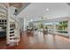 Spacious living room with spiral staircase, hardwood floors, large windows, and natural light at 12820 Butler Bay Ct, Windermere, FL 34786