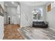 Spacious living room featuring hard wood floors, a couch, and an open view to other rooms at 12820 Butler Bay Ct, Windermere, FL 34786