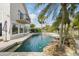 Inviting backyard pool with lush tropical landscaping and a raised spa providing a relaxing outdoor oasis at 12820 Butler Bay Ct, Windermere, FL 34786