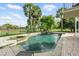 A luxurious pool with a waterfall feature, surrounded by tropical landscaping, offering a private oasis at 12820 Butler Bay Ct, Windermere, FL 34786