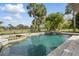 A luxurious pool offers a tranquil escape with its soothing waterfall and surrounding lush greenery in the backyard at 12820 Butler Bay Ct, Windermere, FL 34786