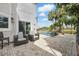 Beautiful poolside patio with ample seating and views of the pool, palm trees, and lush surroundings at 12820 Butler Bay Ct, Windermere, FL 34786