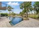 Inviting swimming pool featuring a waterfall feature and poolside seating amidst tropical landscaping at 12820 Butler Bay Ct, Windermere, FL 34786