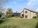 A large backyard showcases a lush lawn, a playset, a palm tree and a beautiful outdoor screened pool at 12860 Jacob Grace Ct, Windermere, FL 34786