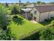 Expansive backyard with a screened-in pool, lush lawn, mature trees, and a patio area at 12860 Jacob Grace Ct, Windermere, FL 34786
