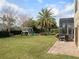 Spacious backyard featuring a playset, lush lawn, palm tree, and screened patio with seating area at 12860 Jacob Grace Ct, Windermere, FL 34786