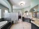 Elegant bathroom featuring glass block shower surround, soaking tub, and dual vanities with granite countertops at 12860 Jacob Grace Ct, Windermere, FL 34786