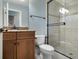 Bathroom with granite countertops, framed mirror, glass enclosed shower, and tiled floors at 12860 Jacob Grace Ct, Windermere, FL 34786