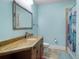 Serene bathroom featuring a large mirror, vanity with stone countertop, and tiled shower at 12860 Jacob Grace Ct, Windermere, FL 34786