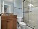 Bathroom featuring a glass-enclosed shower and a wood vanity with granite countertop at 12860 Jacob Grace Ct, Windermere, FL 34786