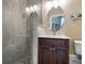 Bathroom featuring a glass-enclosed shower and a vanity with granite countertop at 12860 Jacob Grace Ct, Windermere, FL 34786