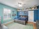 Bright bedroom with blue walls, a custom bedframe, shutters and a ceiling fan at 12860 Jacob Grace Ct, Windermere, FL 34786