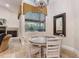 Cozy dining area with chandelier, a window with a view, and tile flooring at 12860 Jacob Grace Ct, Windermere, FL 34786