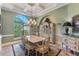 Formal dining room features tray ceilings, large window, chandelier, and decorative furnishings at 12860 Jacob Grace Ct, Windermere, FL 34786