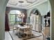 Formal dining room with decorative chandelier, ornate china cabinet, and ample natural light at 12860 Jacob Grace Ct, Windermere, FL 34786