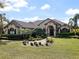 Charming, single-story stucco home with manicured landscaping and a beautiful brick-paved walkway leading to the front door at 12860 Jacob Grace Ct, Windermere, FL 34786