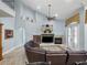 Cozy living room with high ceilings, a fireplace, built-in shelves, and a comfortable leather sectional at 12860 Jacob Grace Ct, Windermere, FL 34786