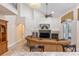 Spacious living room with fireplace, tv, view of balcony, and archway to hallway at 12860 Jacob Grace Ct, Windermere, FL 34786
