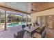 Covered patio with outdoor dining set, columns, wood ceiling, and pool view at 12860 Jacob Grace Ct, Windermere, FL 34786