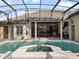 Stunning covered pool with spa, travertine deck, and outdoor kitchen is the ideal place for entertaining guests at 12860 Jacob Grace Ct, Windermere, FL 34786