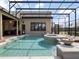 Fabulous screened-in pool with travertine deck, outdoor kitchen, and jacuzzi offers luxurious outdoor living at 12860 Jacob Grace Ct, Windermere, FL 34786