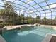 Clear, screened pool features a spa, fountains, and brick pavers for an added elegant touch at 12860 Jacob Grace Ct, Windermere, FL 34786