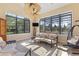 Sunroom with large windows overlooking backyard, ceiling fan, tile floors, and neutral furniture at 12860 Jacob Grace Ct, Windermere, FL 34786
