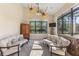 Sunroom with large windows overlooking backyard, ceiling fan, tile floors, and neutral furniture at 12860 Jacob Grace Ct, Windermere, FL 34786