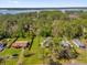 Aerial view of property showing the surrounding landscape, mature trees, and lake in the distance at 13128 Devonshire Rd, Orlando, FL 32832