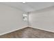 Light-filled bedroom with a window, featuring modern grey wood floors at 13128 Devonshire Rd, Orlando, FL 32832