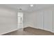 Bedroom with closet and doorway, featuring modern grey wood floors and white trim at 13128 Devonshire Rd, Orlando, FL 32832