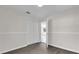 Bedroom with closet and doorway, featuring modern grey wood floors and white trim at 13128 Devonshire Rd, Orlando, FL 32832