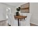 Bright dining room featuring wood table, white chairs, and artistic decor at 13128 Devonshire Rd, Orlando, FL 32832