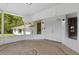 Covered porch with neutral tile flooring and double front doors at 13128 Devonshire Rd, Orlando, FL 32832