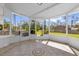 Screened porch with tile flooring overlooking the backyard at 13128 Devonshire Rd, Orlando, FL 32832