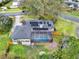 Aerial view of a single-Gathering home with a screened-in pool and solar panels on the roof at 137 Spring Chase Cir, Altamonte Springs, FL 32714