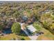 Aerial view showcases the community amenities: basketball court, tennis court, sand volleyball, building, and adjacent stream at 137 Spring Chase Cir, Altamonte Springs, FL 32714