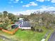 Aerial view of a home with a screened pool enclosure, privacy fence, and beautifully landscaped yard at 137 Spring Chase Cir, Altamonte Springs, FL 32714