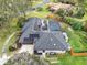 Aerial view showcases home with gray roof, solar panels, and driveway entrance to the attached garage at 137 Spring Chase Cir, Altamonte Springs, FL 32714