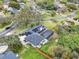 Aerial view showcases a large property, fenced yard, pool, solar panels, and lush greenery in the neighborhood at 137 Spring Chase Cir, Altamonte Springs, FL 32714