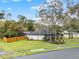 View of backyard showing the home, new fence, lush lawn and trees with mature landscaping at 137 Spring Chase Cir, Altamonte Springs, FL 32714