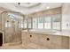 Bright bathroom featuring a soaking tub with white shutters, and a glass enclosed shower at 137 Spring Chase Cir, Altamonte Springs, FL 32714