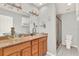 Bathroom featuring dual sinks with granite countertop, modern faucet, and walk-in shower at 137 Spring Chase Cir, Altamonte Springs, FL 32714