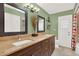 Bathroom featuring a double vanity with granite countertop, framed mirrors, decorative vase and tiled floor at 137 Spring Chase Cir, Altamonte Springs, FL 32714