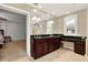 Elegant bathroom features a dark wood double vanity, granite countertop and a large mirror reflecting the glass shower at 137 Spring Chase Cir, Altamonte Springs, FL 32714